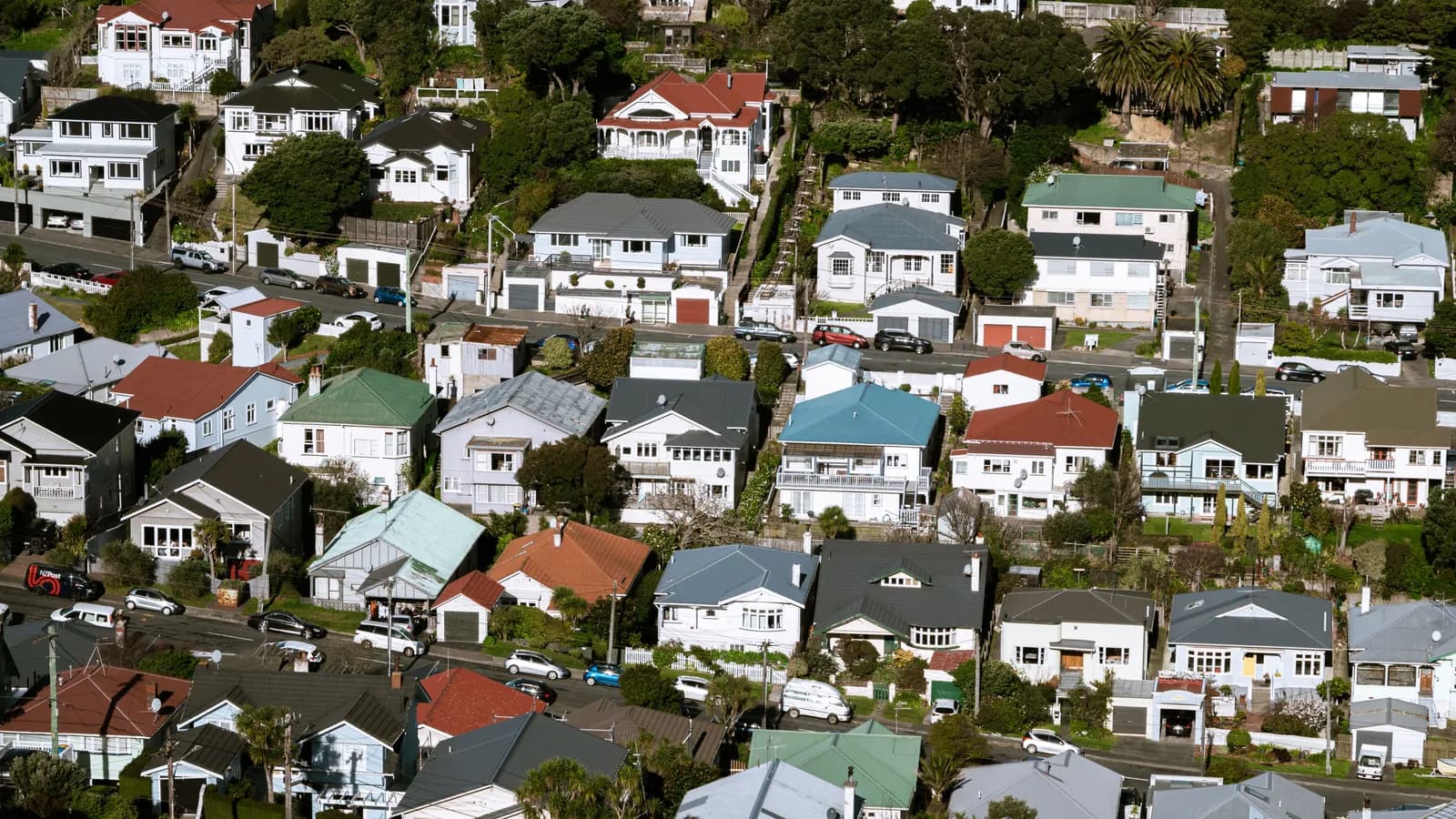 Aerial view of a New Zealand residential suburb, with an NZ Post van visible on the street