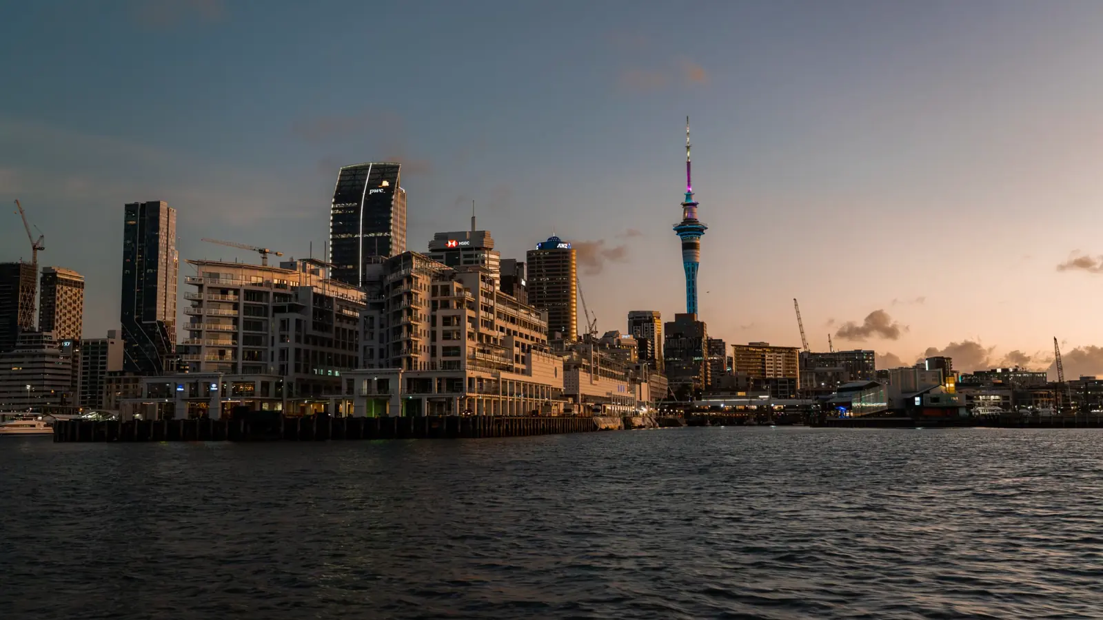 Auckland city skyline and waterfront at dusk, including the Sky Tower