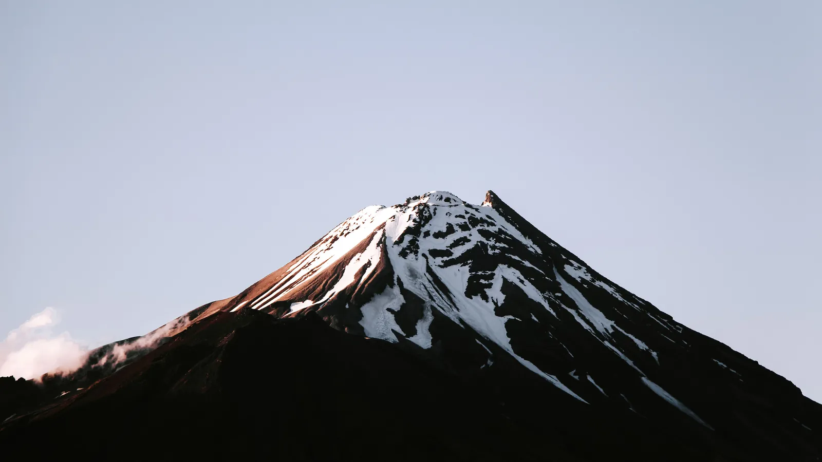 Snow-capped volcanic peak against a clear sky